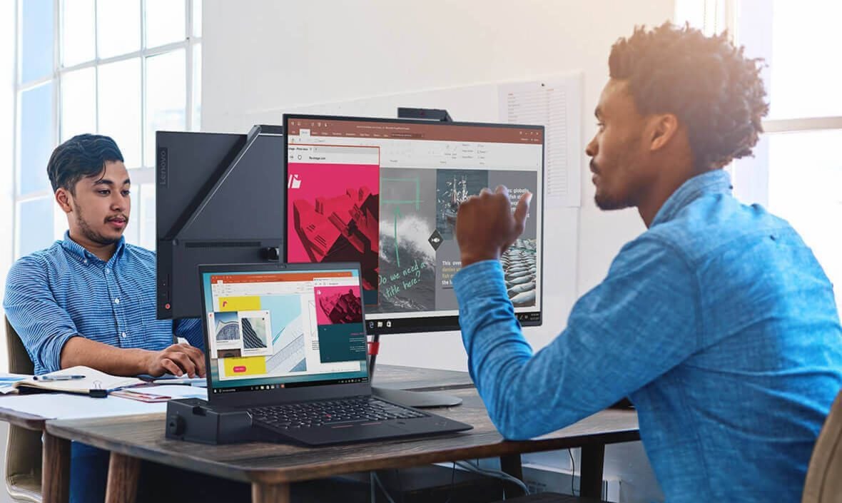 Lenovo ThinkPad X1 Carbon (6th Gen) being used in a workspace with screen extended across a monitor.