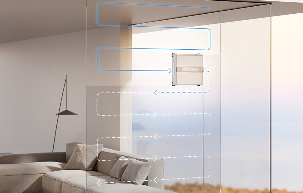 Robot do mycia szyb porusza się po dużej szklanej ścianie z zaznaczoną ścieżką pracy