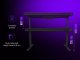 Dual-motor sit/stand adjustable-height gaming desk with built-in PC case, wireless charger, RGB lighting, control panel, and USB ports, tempered glass tabletop, black. 2